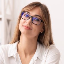 confident-businesswoman-smiling-at-camera-sitting-NHJXPND.jpg
